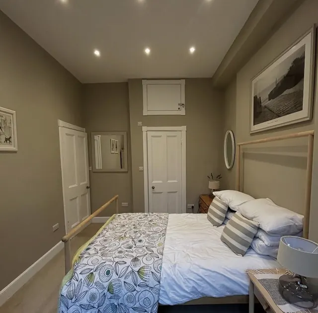 Freshly decorated bedroom in a warm neutral with white woodwork