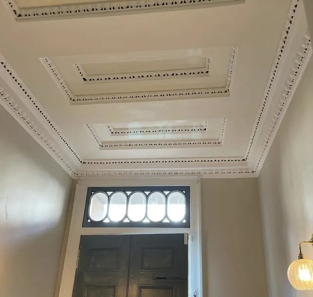 Ornate hallway ceiling with restored cornicing