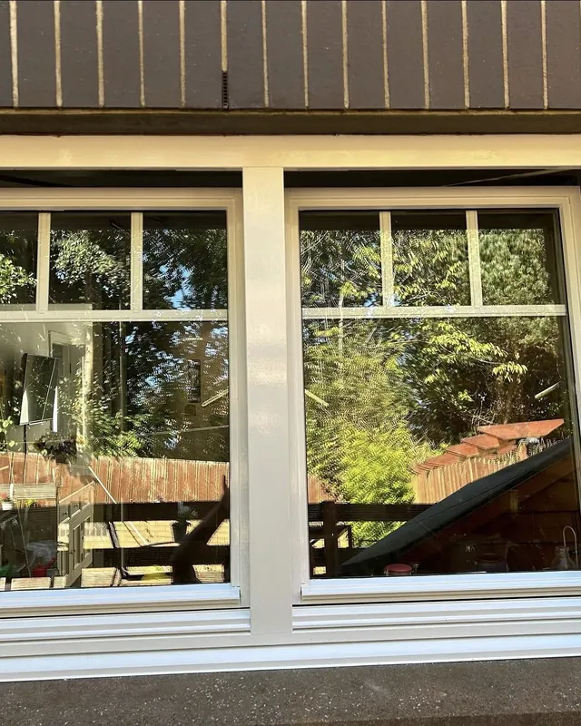 Exterior window frames repainted in a clean off-white gloss